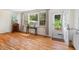 Bright living room with hardwood floors, large windows and an open door to the backyard at 122 W Woodridge Dr, Durham, NC 27707