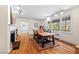 Open living area with hardwood floors, fireplace, large windows, and natural light at 122 W Woodridge Dr, Durham, NC 27707