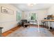 Comfortable office space featuring a leather chair, rug, and ample natural light at 122 W Woodridge Dr, Durham, NC 27707
