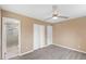 Bedroom with hardwood floors, fan and closet leading into bathroom with glass enclosed shower at 1230 Melrose Dr, Burlington, NC 27217