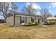 Charming single-story home with black shutters and a well-manicured lawn at 1230 Melrose Dr, Burlington, NC 27217