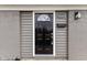 Close-up of a stylish black front door with a decorative window and modern lighting fixture at 1230 Melrose Dr, Burlington, NC 27217