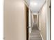 Well-lit hallway with modern flooring and multiple doors at 1230 Melrose Dr, Burlington, NC 27217