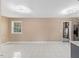 Spacious living room with tile floors, large windows and modern ceiling lights at 1230 Melrose Dr, Burlington, NC 27217