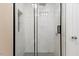 A modern shower with glass doors and tiled walls, showcasing a sleek design at 1230 Melrose Dr, Burlington, NC 27217