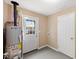 Utility room featuring a water heater and access to the exterior at 1230 Melrose Dr, Burlington, NC 27217