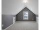Attic space offering extra room, featuring neutral carpeting and dormer window at 125 Station Dr, Morrisville, NC 27560
