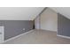 Upstairs attic room with light colored carpeting and painted walls at 125 Station Dr, Morrisville, NC 27560