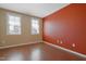 Bedroom with hard wood floors and abundant natural light from two windows at 125 Station Dr, Morrisville, NC 27560