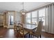 Bright dining room features large windows, wood floors, modern lighting and seating for six at 125 Station Dr, Morrisville, NC 27560