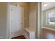Inviting entryway with coat rack and bench, featuring hardwood floors and natural light from a nearby window at 125 Station Dr, Morrisville, NC 27560