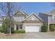 Charming home with stone accents, inviting facade, a two-car garage and well-manicured landscaping at 125 Station Dr, Morrisville, NC 27560