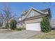 Charming home features a stone facade and a two-car garage, enhancing curb appeal at 125 Station Dr, Morrisville, NC 27560