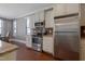 Well-appointed kitchen featuring stainless steel appliances, granite countertops, and white cabinets with hardwood floors at 125 Station Dr, Morrisville, NC 27560
