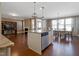 Open kitchen with a granite island, stainless steel dishwasher, flowing seamlessly into the dining and living areas at 125 Station Dr, Morrisville, NC 27560