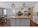 Modern kitchen with a granite island, white cabinetry, and stainless-steel appliances, open to the dining area at 125 Station Dr, Morrisville, NC 27560