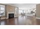 Open concept living area featuring hardwood floors, fireplace, kitchen island, and dining area with ample light at 125 Station Dr, Morrisville, NC 27560