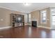 Cozy living room featuring a fireplace, built-in shelving, hardwood flooring, and plentiful natural light at 125 Station Dr, Morrisville, NC 27560