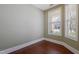 Bright, vacant room featuring two large windows, neutral walls, and pristine dark hardwood flooring at 125 Station Dr, Morrisville, NC 27560