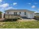 White home's backyard with wooden deck, grassy lawn, and mature trees at 125 Wynnridge Dr, Angier, NC 27501