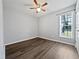 A simple bedroom has a ceiling fan, new floors, and a window for natural light at 125 Wynnridge Dr, Angier, NC 27501