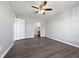 A spacious room with sleek, dark wood-style flooring, and a modern ceiling fan at 125 Wynnridge Dr, Angier, NC 27501