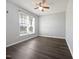 This bedroom has wood-look floors, a ceiling fan, and a window for natural light at 125 Wynnridge Dr, Angier, NC 27501