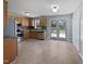 Well-lit kitchen featuring wood cabinets, stainless steel appliances, and a double door to the yard at 125 Wynnridge Dr, Angier, NC 27501