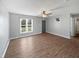 Bright living room with wood-look floors, a ceiling fan, neutral walls, and large windows at 125 Wynnridge Dr, Angier, NC 27501