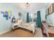 Charming bedroom featuring a crystal chandelier, ample natural light, and stylish decor, creating a cozy retreat at 132 Fiori Hill S Dr, Hillsborough, NC 27278