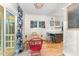 Dining area with wood table and colorful chairs, open to kitchen and sliding door to deck at 132 Fiori Hill S Dr, Hillsborough, NC 27278