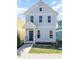 Charming two-story home with light blue siding, white trim, and a welcoming front porch at 132 Fiori Hill S Dr, Hillsborough, NC 27278