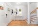 Bright foyer features hardwood floors, a staircase, and a stylish console table at 132 Fiori Hill S Dr, Hillsborough, NC 27278