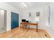 Home office featuring hardwood floors, natural light, a writing desk, and a bright blue closet door at 132 Fiori Hill S Dr, Hillsborough, NC 27278