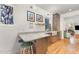 Eat-in kitchen featuring a marble countertop with a breakfast bar, stainless steel appliances, and hardwood floors at 132 Fiori Hill S Dr, Hillsborough, NC 27278