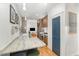 Bright eat-in kitchen with marble countertops, hardwood floors, stainless steel appliances, and view into living room at 132 Fiori Hill S Dr, Hillsborough, NC 27278