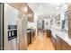 Modern kitchen features stainless steel appliances, white marble countertops, and dark cabinets at 132 Fiori Hill S Dr, Hillsborough, NC 27278