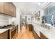 Modern kitchen featuring stainless steel appliances, white marble countertops, and dark cabinets at 132 Fiori Hill S Dr, Hillsborough, NC 27278
