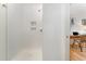 Bright shower with white tile and decorative inset shelving, adjacent to a small office nook at 132 Fiori Hill S Dr, Hillsborough, NC 27278