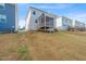 Lawn view of rear exterior and screened in porch at 1417 Underbrush Dr, Durham, NC 27703
