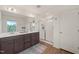 Bright primary bathroom with double vanity, large mirror and glass enclosed shower at 1417 Underbrush Dr, Durham, NC 27703