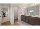 Neutral bathroom featuring double vanity, large mirror, toilet and door to walk-in closet at 1417 Underbrush Dr, Durham, NC 27703