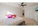 Cozy bedroom featuring comfortable bed, ceiling fan, en suite bathroom and closet at 1417 Underbrush Dr, Durham, NC 27703