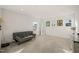 Versatile bedroom featuring a comfy couch, offering a flexible space for relaxing or entertaining, with ample natural light at 1417 Underbrush Dr, Durham, NC 27703