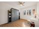 Bright bedroom with a stylish Murphy bed, ample natural light, and ceiling fan at 1417 Underbrush Dr, Durham, NC 27703