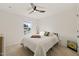 Bright bedroom with a ceiling fan, window, and neutral carpet flooring at 1417 Underbrush Dr, Durham, NC 27703