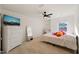 Colorful bedroom with decorative pillows, desk and tall dresser, featuring a ceiling fan at 1417 Underbrush Dr, Durham, NC 27703