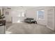 Bright upstairs bonus room with neutral carpet, large window and comfortable grey futon couch at 1417 Underbrush Dr, Durham, NC 27703