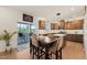 Open dining area featuring wooden table and chairs with views to an outdoor patio and kitchen space at 1417 Underbrush Dr, Durham, NC 27703