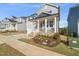 Charming home exterior featuring a welcoming front porch, landscaped garden, and a cozy curb appeal at 1417 Underbrush Dr, Durham, NC 27703